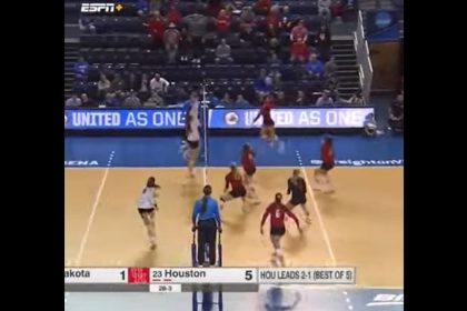A volleyball player dives to save a point
