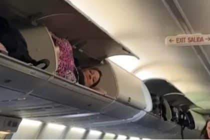 Passenger climbs into overhead cabin