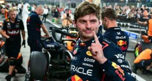 Max Verstappen stands near the Red Bull Racing car after Abu Dhabi Grand Prix qualifying at Yas Marina Circuit.