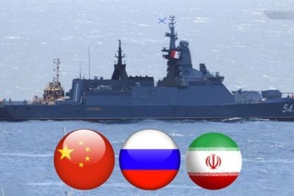 ALT Text: A naval warship sails at sea above circular flag icons for China, Russia and Iran.