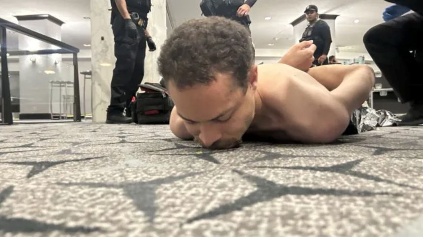 Cole Tomas Allen lying on the ground in handcuffs after his arrest in the WHCA dinner shooting case.