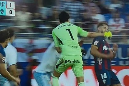 Real Zaragoza goalkeeper Esteban Andrada throws a punch during a heated late moment in the match against Huesca.