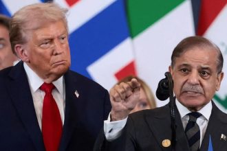 U.S. President Donald Trump stands beside Pakistan’s Prime Minister Shehbaz Sharif during a world leaders’ summit on ending the Gaza war in Sharm El-Sheikh, Egypt, on October 13, 2025.