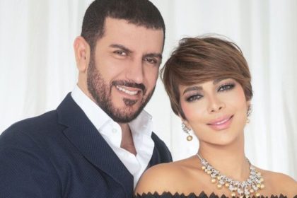 Iraqi poet Faiq Hassan stands beside his wife, Syrian singer Asala Nasri, in a studio-style portrait.