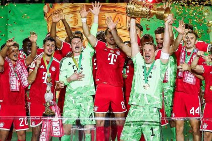 Bayern Munich players celebrate on the pitch after beating Stuttgart 3-0 in the German Cup final.