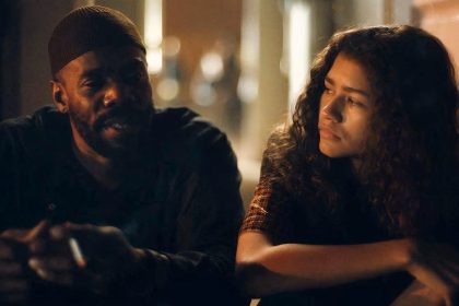 Colman Domingo and Zendaya sit side by side in a dimly lit scene from Euphoria.