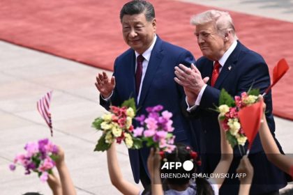 U.S. President Donald Trump and Chinese President Xi Jinping wave during a meeting at Beijing’s Great Hall of the People on May 14, 2026.
