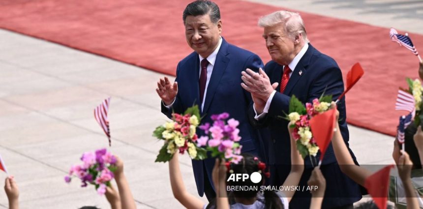 U.S. President Donald Trump and Chinese President Xi Jinping wave during a meeting at Beijing’s Great Hall of the People on May 14, 2026.