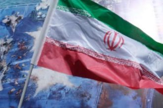 Iranian flag displayed prominently with fighter jets and military visuals in the background during a geopolitical news graphic. Image Credit: Screengrab / CNBC Video