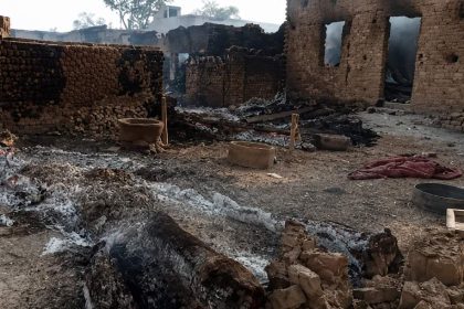 Charred mud-brick structures, ash and burned debris cover a damaged compound after an arson incident in Jacobabad, Sindh.