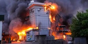 A building in Kyiv burns with large flames and heavy black smoke after missile attack debris reportedly caught fire on school premises.