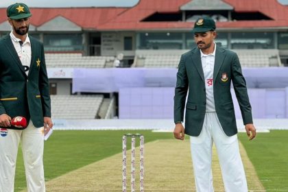 Pakistan and Bangladesh captains stand near the stumps on the pitch during the toss before the second Test match.