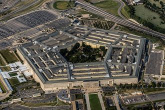 Aerial view of the Pentagon building complex with parking lots and roads around it.