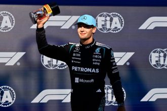 George Russell raises a trophy while celebrating Mercedes’ sprint race pole position at the Canadian Grand Prix.