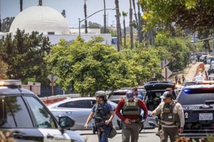San Diego police vehicles and armed officers gather near a mosque during an emergency response.