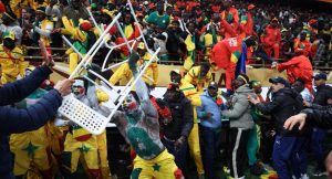 Senegal fans and security personnel clash near the stands after fans entered the pitch during the Africa Cup of Nations final.