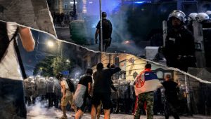 Protesters face a line of riot police with shields during smoky nighttime clashes in Belgrade, Serbia.