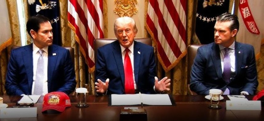 Donald Trump seated between Marco Rubio and Pete Hegseth during a formal meeting.