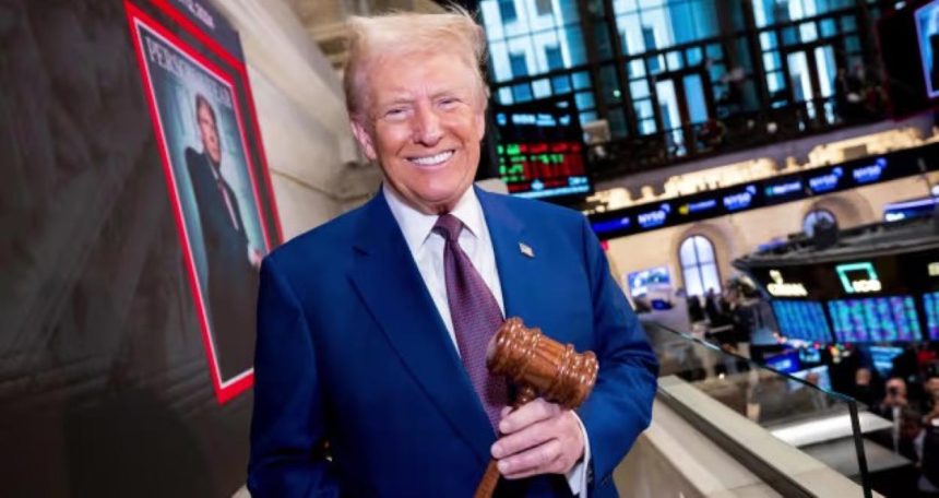 President-elect Donald Trump smiles while holding a gavel at the New York Stock Exchange during a visit to ring the Opening Bell.