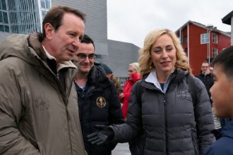 Jeff Landry, President Donald Trump’s Greenland envoy, speaks with a local boy in Nuuk while standing with members of a visiting delegation.