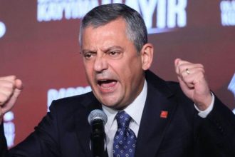 Özgür Özel, leader of Turkey’s Republican People’s Party, speaks into a microphone with raised fists during an event in Ankara.