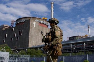 A Russian serviceman patrols outside the Zaporizhzhia Nuclear Power Plant in southeastern Ukraine.