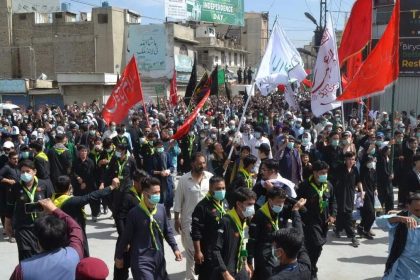 Ashura Quetta Balochistan procession showing mourners carrying religious flags.