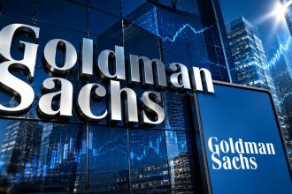 Goldman Sachs logo on a glass building with blue financial charts and city skyscrapers in the background.