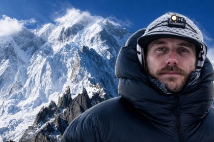 French climber Guillaume Pierrel shown with snow-covered mountains after an avalanche on K-6 in Gilgit-Baltistan.