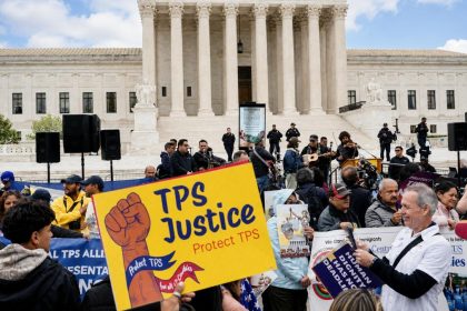 Immigrants’ rights demonstrators rally outside the U.S. Supreme Court in Washington with TPS Justice signs.