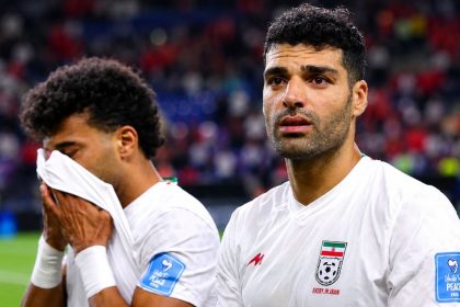Iran football players reacting emotionally after a World Cup match.