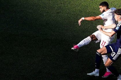 Morocco and Scotland footballers challenge for the ball during a World Cup match at Gillette Stadium.