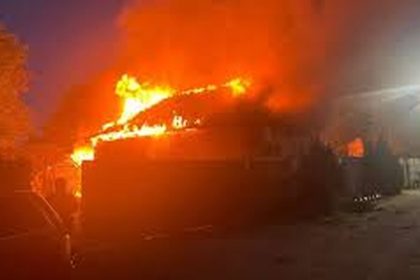 A burning vehicle sends flames and smoke into the night sky after a reported Russian strike in Konotop.
