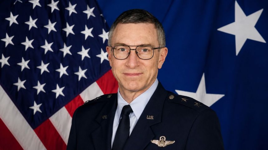 Retired U.S. Air Force Maj. Gen. William Neil McCasland in uniform with the American flag behind him