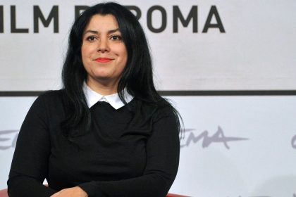 French-Iranian author and filmmaker Marjane Satrapi sits in front of a Film Roma backdrop in Rome, Italy.