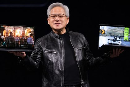 Nvidia CEO Jensen Huang holds two laptops during his Computex 2026 keynote in Taipei.