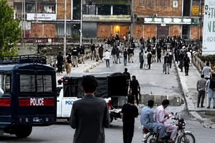 Police vehicles and crowds gather near CMH Rawalakot after a banned JAAC attack killed five security personnel and injured more than 20 people.