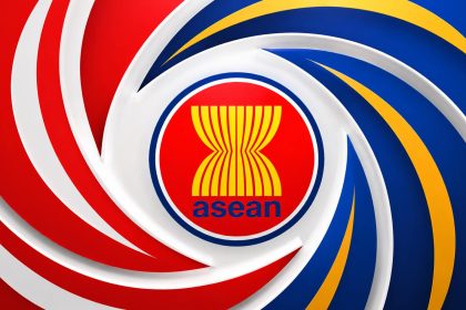 Association of Southeast Asian Nations ASEAN emblem on a multicoloured background.