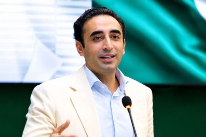 Bilawal Bhutto Zardari speaking at a public event while addressing an audience with a microphone.