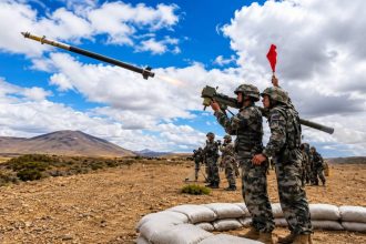 Chinese soldiers launch a Chinese MANPADS missile during a live-fire military training exercise.