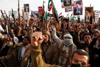 Pro-Iran protesters carrying Yemen and Iran flags at a rally in Sana’a