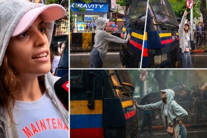 Indian model and actor Rhiya Ahir blocks a Mumbai Police van during a protest in Mumbai, calling for the release of detained student protesters on July 22.