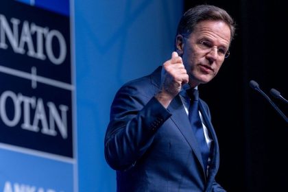 NATO Secretary General Mark Rutte at Ankara Summit speaking beside NATO sign.