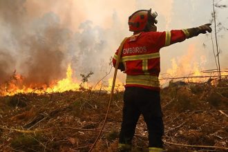 Firefighter battles flames during Spain and Portugal wildfires near Costa Brava and northern Portugal.