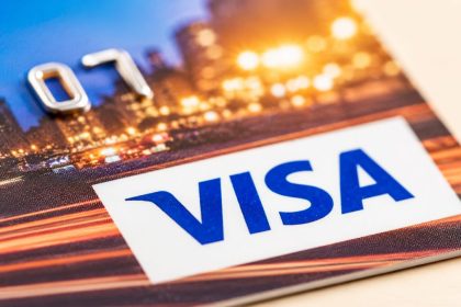 Close-up of a Visa credit card with the Visa logo prominently displayed, symbolizing digital payments and financial services.