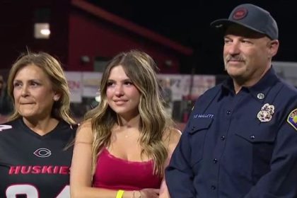 Brooklyn Mallett with firefighter at Centennial High School Heroes Night ceremony.