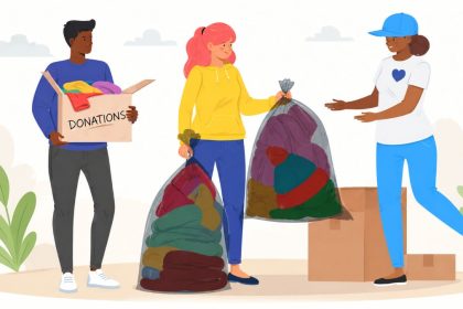 Three volunteers collecting and sorting donated clothes during a community clothing drive for people in need.