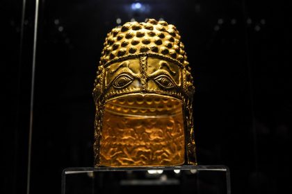 Ancient golden ceremonial helmet on display