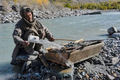 Gold miner working beside a river in Gilgit-Baltistan