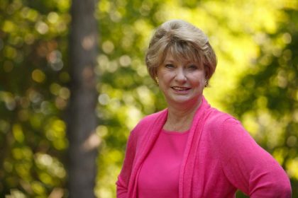 Former Virginia Democratic State Senator Janet Howell posing outdoors in a pink outfit during a portrait photograph.